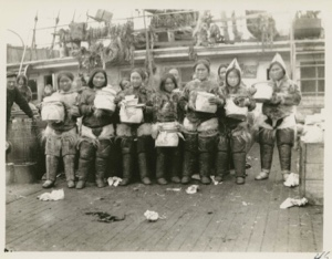 Image of Eskimo [Inughuit] women receiving presents on deck of S.S. Roosevelt